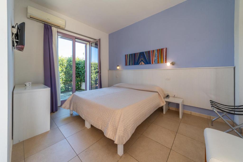 Postel nebo postele na pokoji v ubytování Corte dei Melograni Hotel Resort