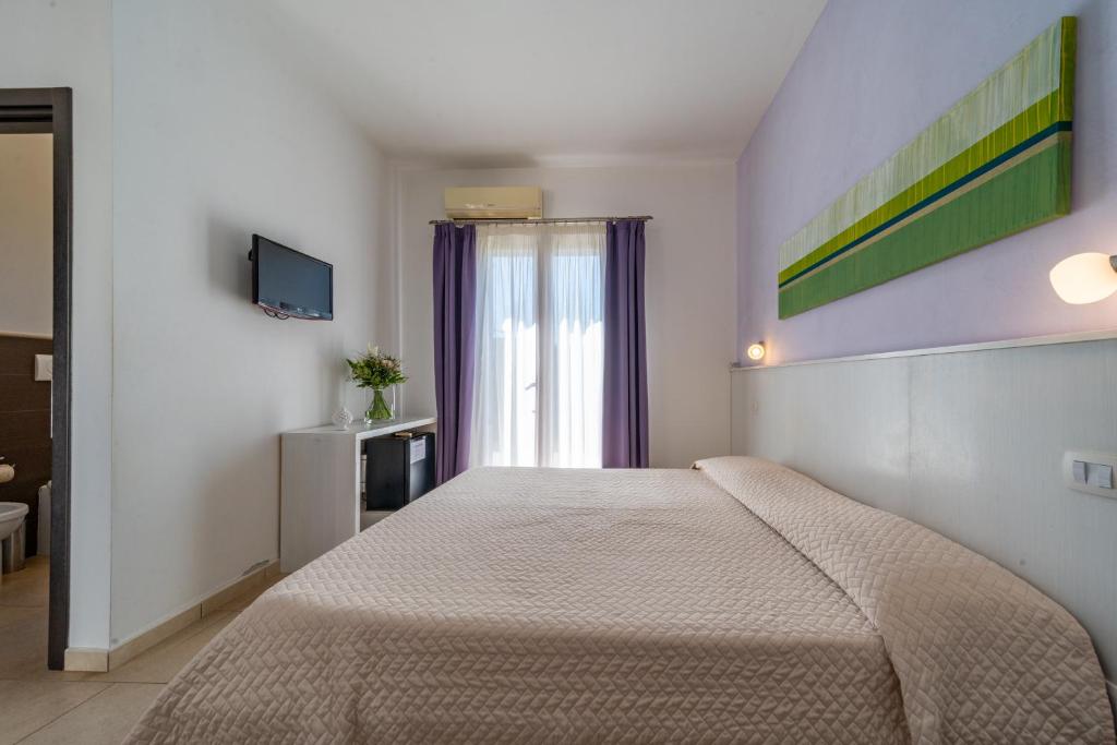 Postel nebo postele na pokoji v ubytování Corte dei Melograni Hotel Resort