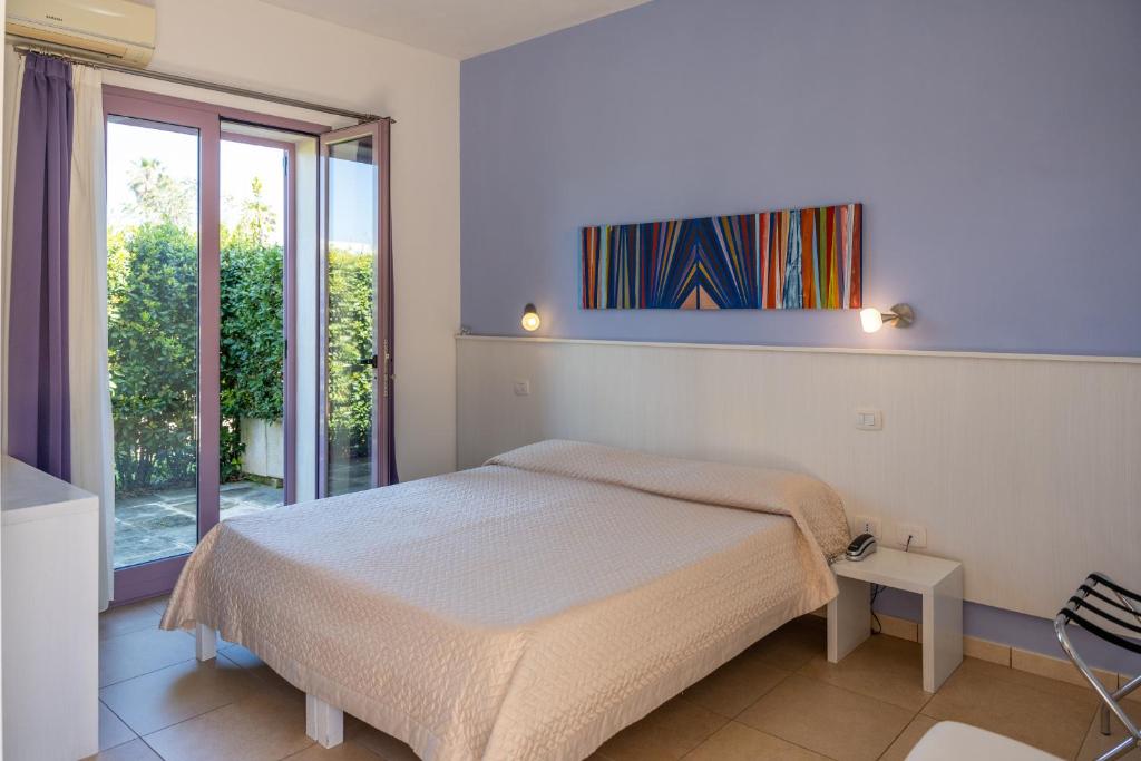 Postel nebo postele na pokoji v ubytování Corte dei Melograni Hotel Resort