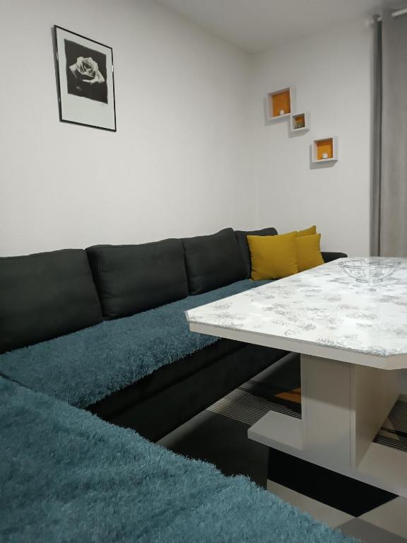 a living room with a couch and a table at Silent home in Visoko