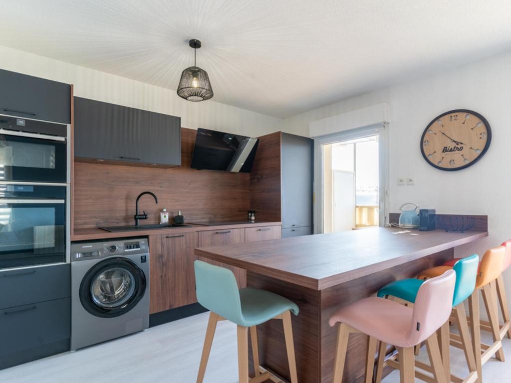 a kitchen with a large wooden table and chairs at Appartement T3 rénové face à la dune, 6 pers., piscine, plage à pied - Biscarrosse - FR-1-319-489 in Biscarrosse