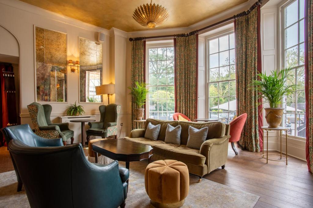 a living room with furniture and large windows at Richmond Hill Hotel in Richmond upon Thames
