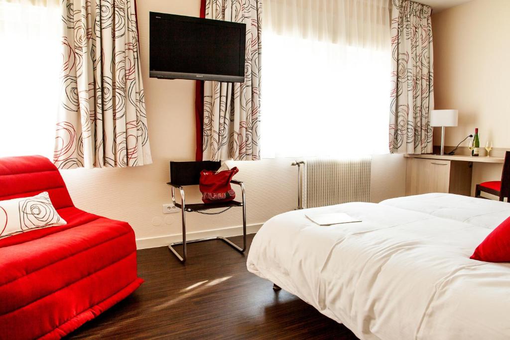 Postel nebo postele na pokoji v ubytování Hôtel Le Ménestrel