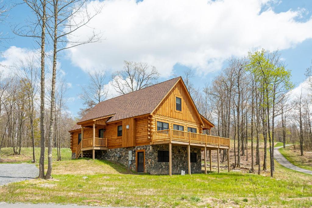 a large wooden house in the middle of a forest at Johns Place in McHenry