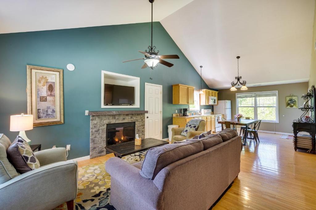 a living room with a couch and a fireplace at Cozy Resort-Style Escape on Taylorsville Lake! in Taylorsville
