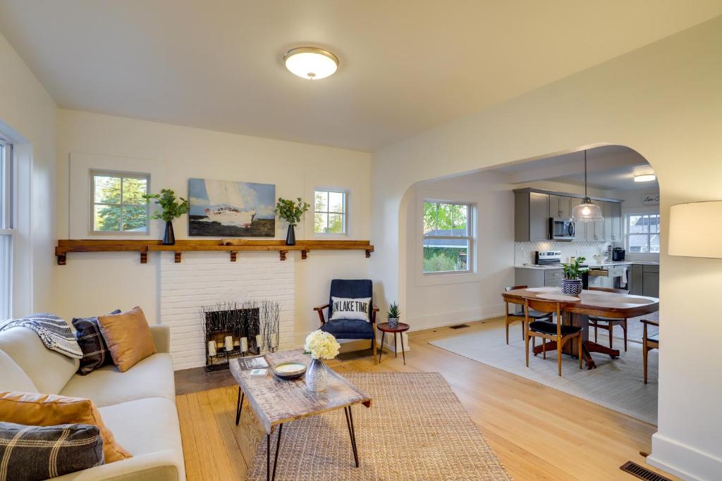 a living room with a fireplace and a table at Indiana Vacation Rental - Walk to Syracuse Lake! in Syracuse