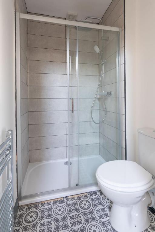 a bathroom with a shower and a toilet at RESIDENCY LUXURY SEAFRONT HOTEL in Blackpool