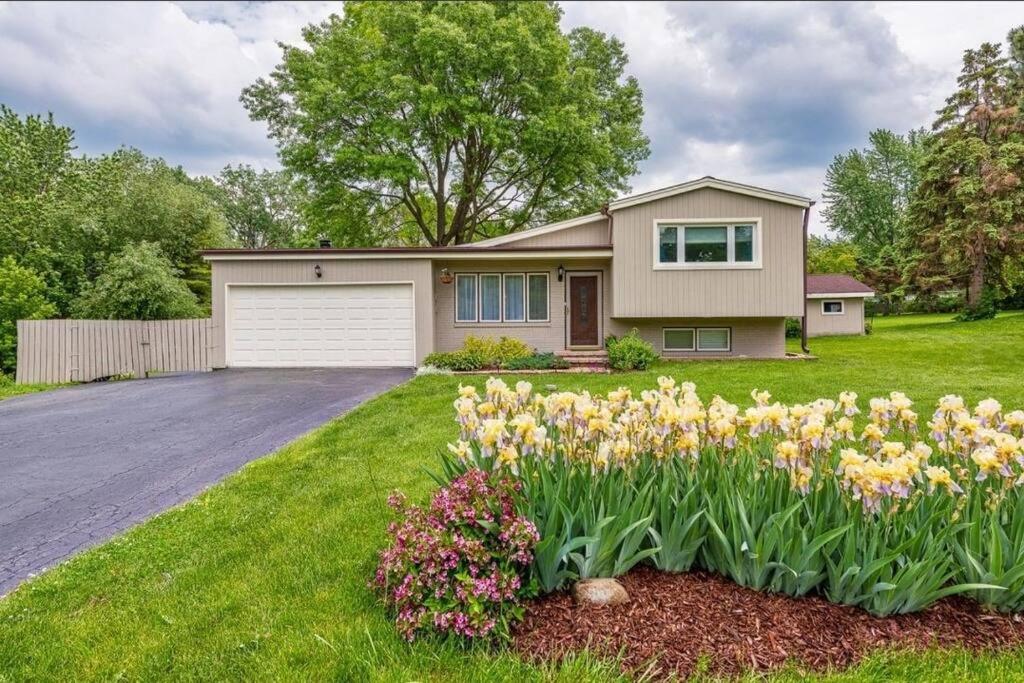 a house with a lot of flowers in the yard at Glen Ellyn Countryside Home in Glen Ellyn