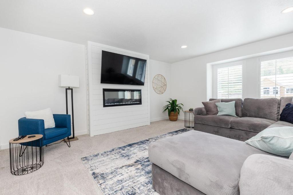 a living room with a couch and a tv at Bear Lake - Mike's Market 3BR2BA EV Charger in Garden City