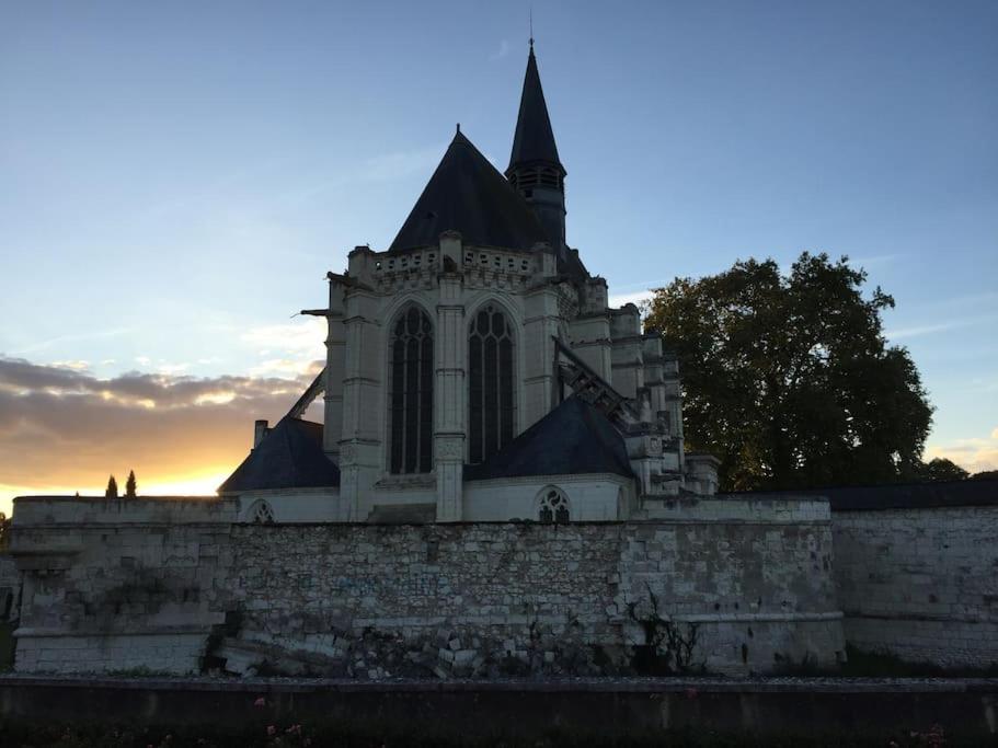 a church sitting on top of a stone wall at La Volière in Champigny-sur-Veude