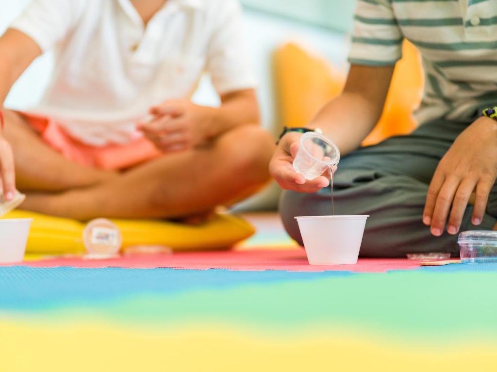 a group of people sitting on the floor drinking from cups at Paradisus Cancun All Inclusive in Cancún