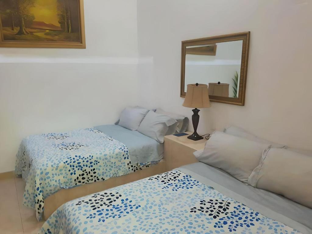 Postel nebo postele na pokoji v ubytování Hotel RJ Querétaro