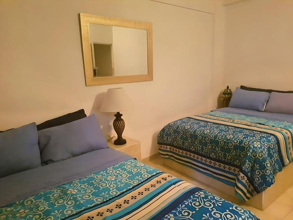 Postel nebo postele na pokoji v ubytování Hotel RJ Querétaro