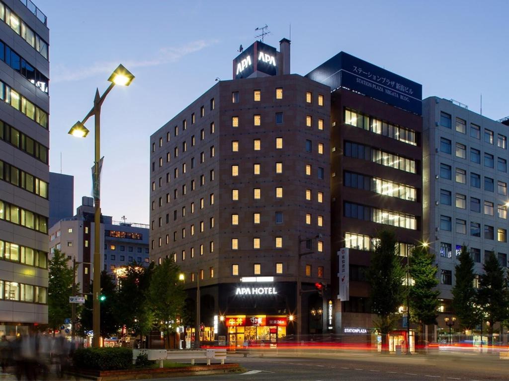 a tall building with a clock on top of it at APA Hotel Niigata in Niigata