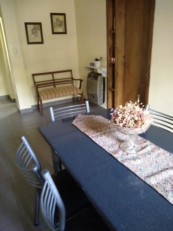 a blue table with chairs and a bowl of flowers on it at Comodo Departamento in San Juan