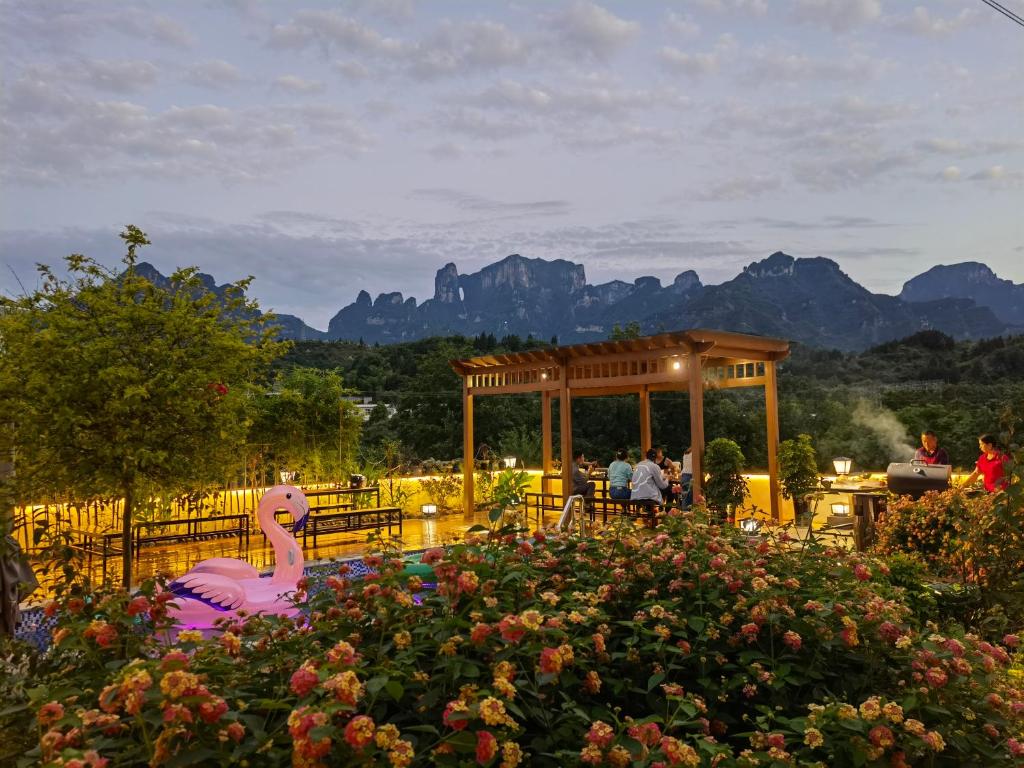 a garden with a pink flamingo in a garden at Heaven's Gate Home Stay in Zhangjiajie