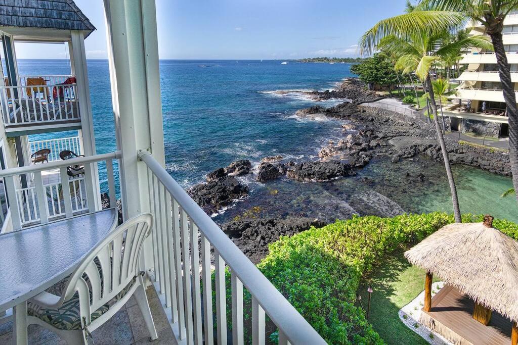 a balcony of a house with a view of the ocean at Condo On the Ocean, Lagoon and Garden - Hale Kona Kai 411 by Casago Kona in Kailua-Kona