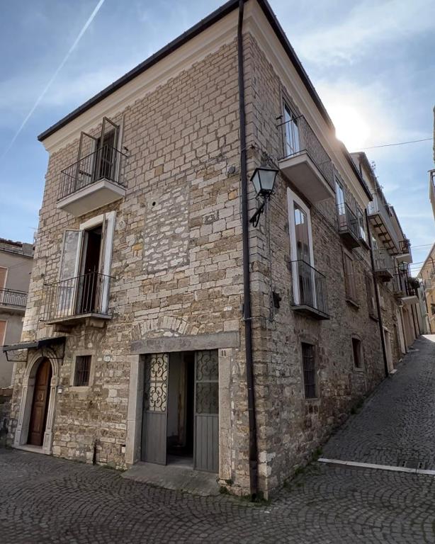 an old brick building on a cobblestone street at Casa Acquaviva in Acquaviva Collecroce