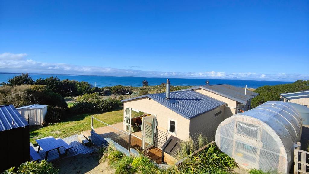 a view of a house and a greenhouse at Spectacular Moana Views in Riverton
