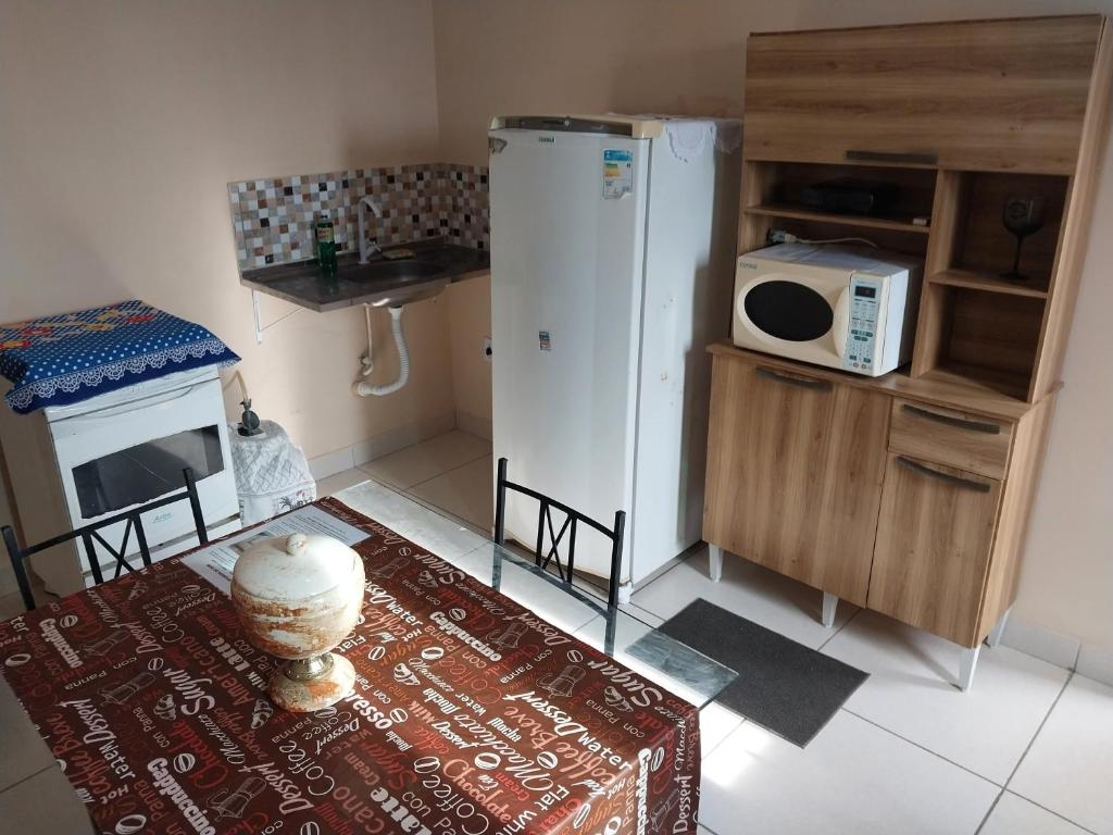 a kitchen with a white refrigerator and a microwave at Parque Jockey Campos in Campos dos Goytacazes