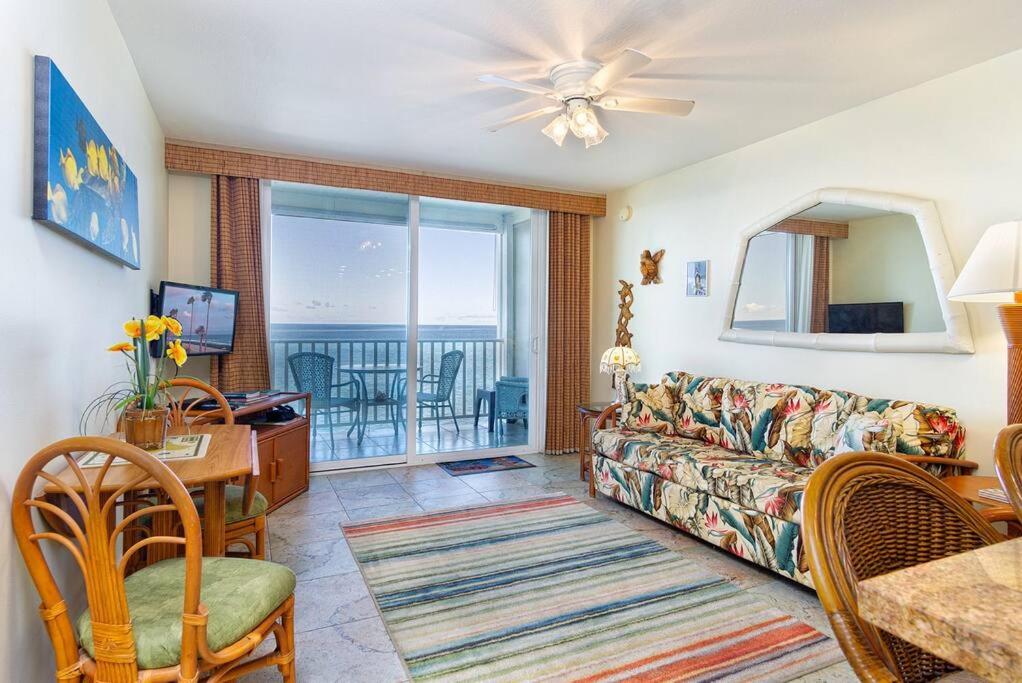 a living room with a couch and a table at Beautifully Renovated Oceanfront Condo w/ breathe taking Views! - Hale Kona Kai 302 in Kailua-Kona