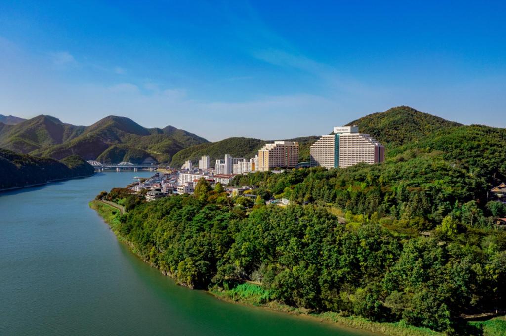 arial view of a river with buildings and trees at Sono Moon Danyang in Danyang