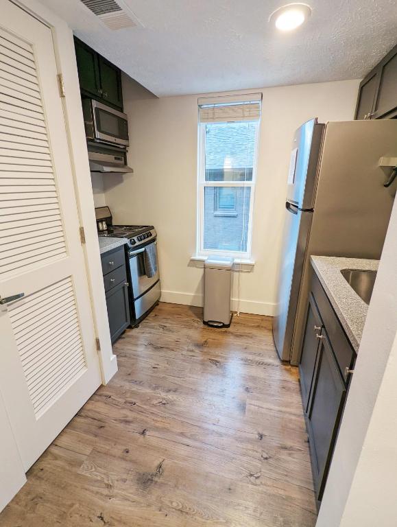 Hotel The Vinyl at Music Row - Garden Suite, a kitchen with a refrigerator and a wooden floor at The Vinyl at Music Row - Garden Suite in Nashville