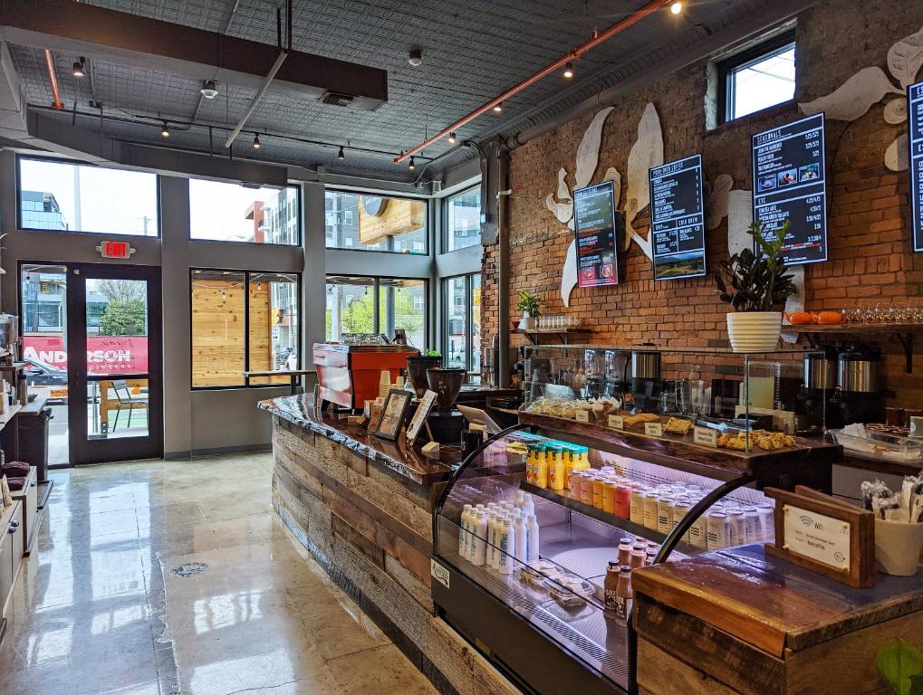 a restaurant with a bakery with a counter at The Vinyl at Music Row - Garden Suite in Nashville