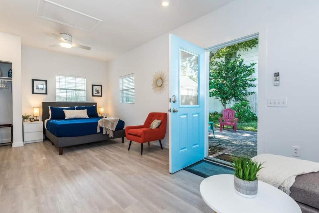 a bedroom with a bed and a couch and a chair at The Studio at Old Mission Walking Distance to Downtown and Onsite Parking in Saint Augustine