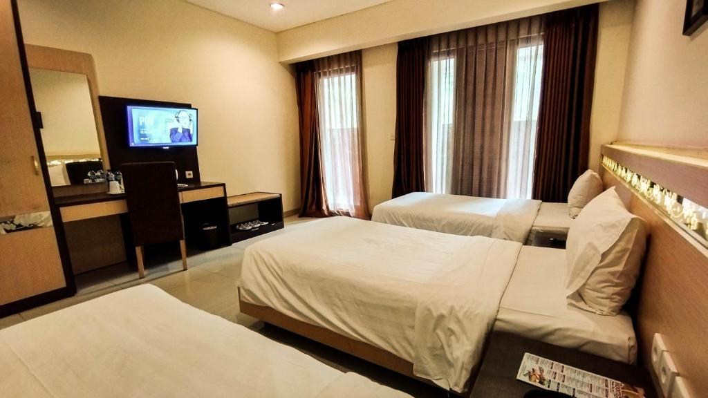 Postel nebo postele na pokoji v ubytování Lembah Permai Resort