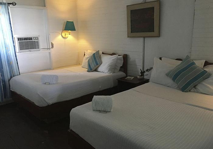 Postel nebo postele na pokoji v ubytování Hostal Corotu
