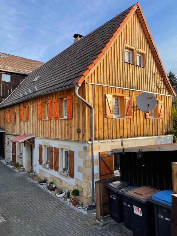 a large wooden house with a basketball hoop on it at Urlaub im Oberstübchen in Lichtenhain