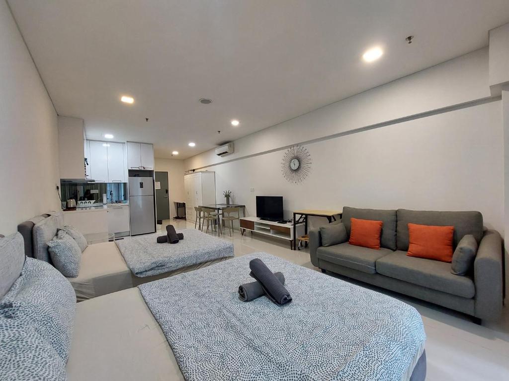 a living room with two couches and a couch at Inspired Homes @ Summer Suite in Kuala Lumpur