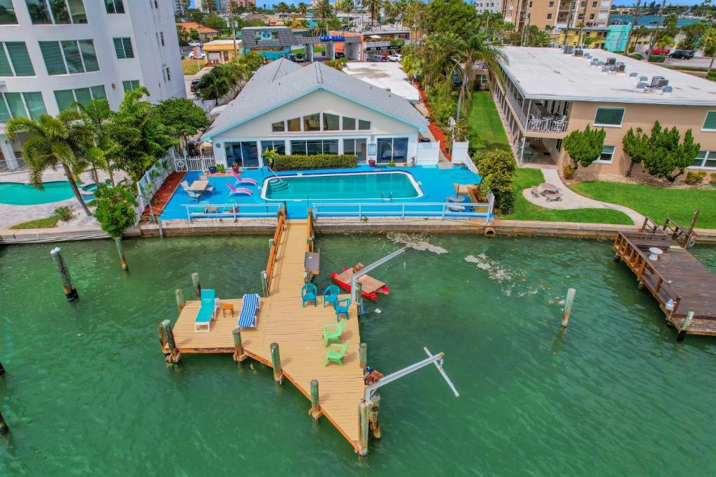 an aerial view of a house with a dock in the water at Dolphin Court #9 in St Pete Beach