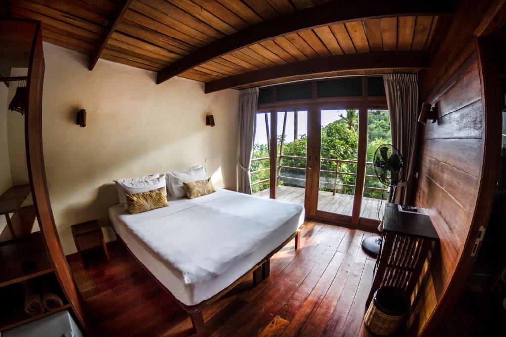 Postel nebo postele na pokoji v ubytování Ecotao Lodge