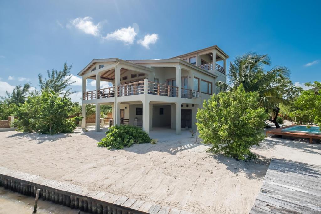 a large white house on the beach at Beachfront Villa Island Pearl Gold Standard Certified in Caye Caulker