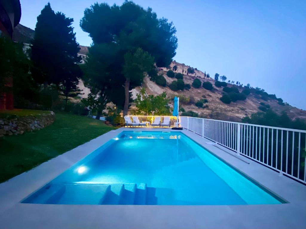 a swimming pool in a backyard with a hill in the background at Villa Romeo, with brand new salt water pool in Benalmádena