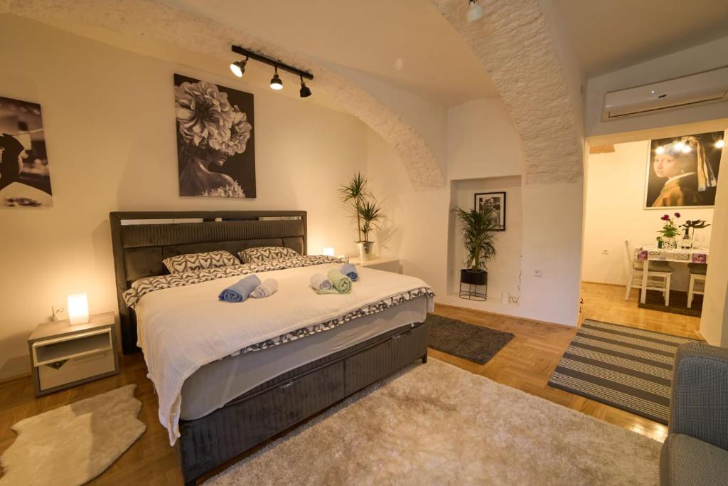 a bedroom with a large bed in a room at Downtown secret apartment in Zagreb