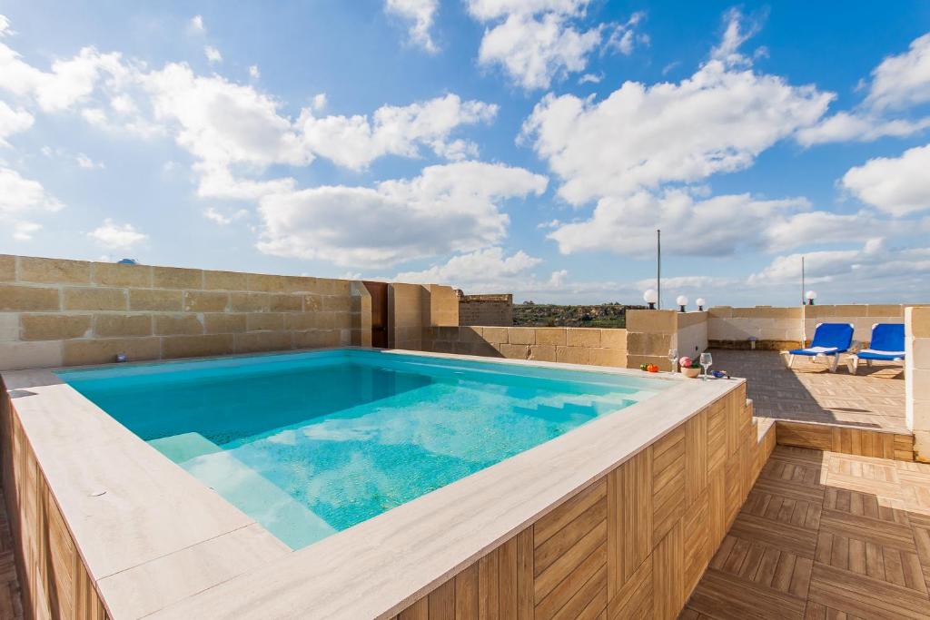 a swimming pool on the roof of a house at Naduri, Beautiful Gozitan Villa plus Pool - Happy Rentals in Nadur