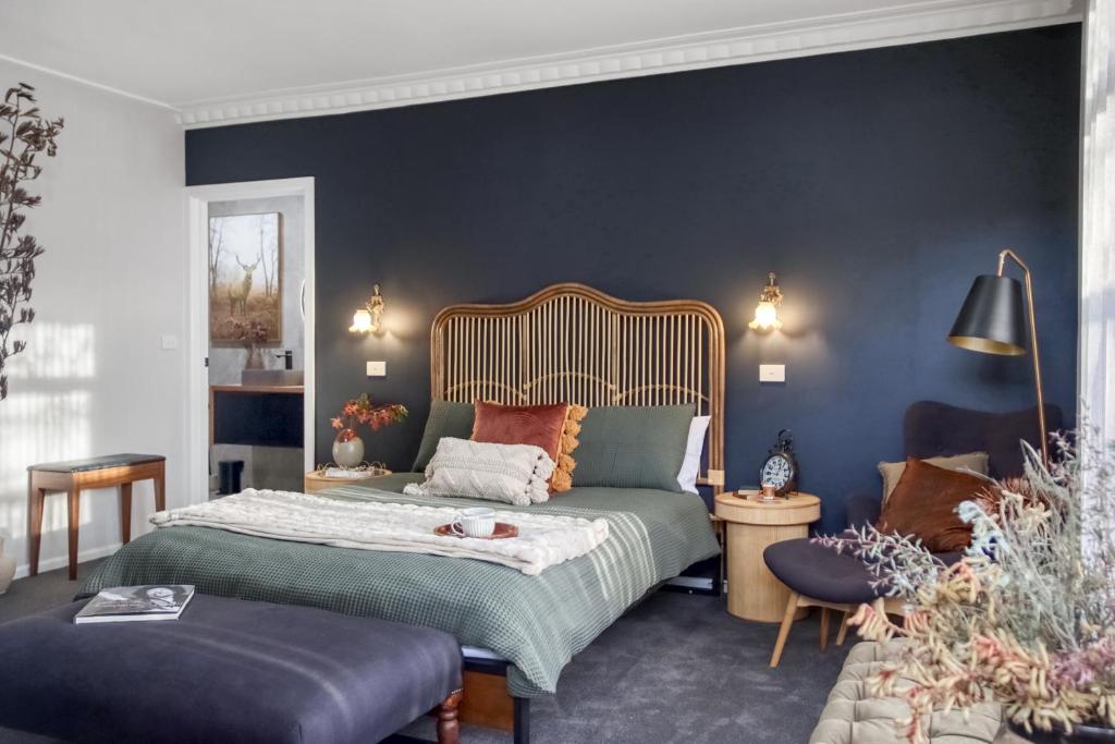 a bedroom with a bed and a blue wall at 16 Scenic by Regional Escapes in Geelong