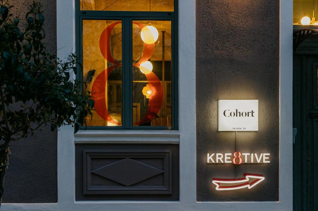 a building with a window with a sign on it at Cohort Koukaki in Athens