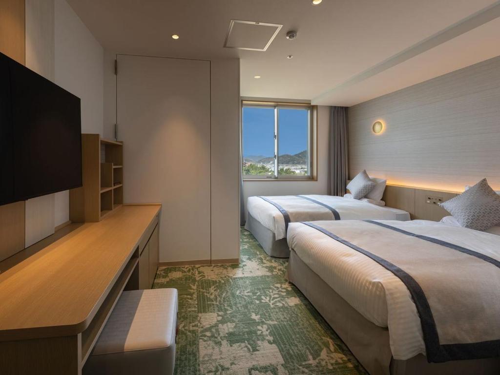 Postel nebo postele na pokoji v ubytování KAMENOI HOTEL Hikone