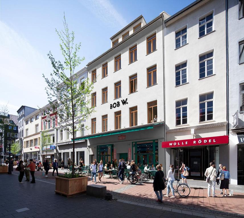 a group of people walking on a city street at Bob W Beethoven in Bonn