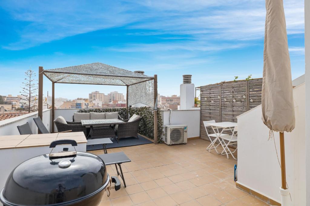 a rooftop patio with a grill and a table on a roof at Smart rooftop in Fuengirola Ref 212 in Fuengirola