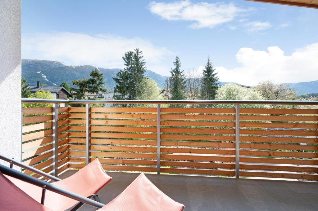 a balcony with a fence with mountains in the background at Haus Mader 2 in Riscone