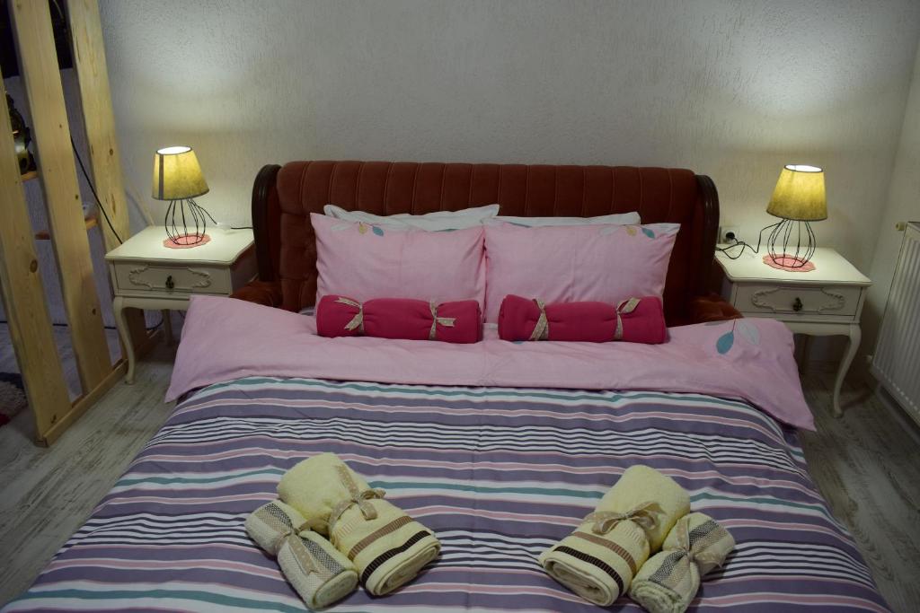 a bedroom with a large bed with two night stands at Villa DIJA in Kruševo