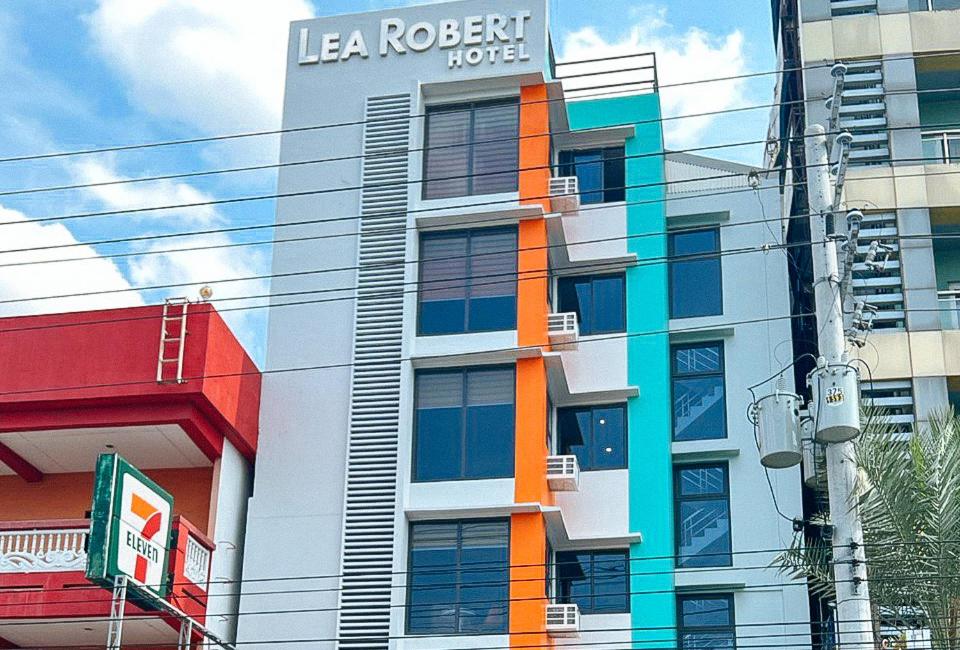 a building with a sign on the side of it at Lea Robert Hotel Angeles Pampanga by RedDoorz in Angeles