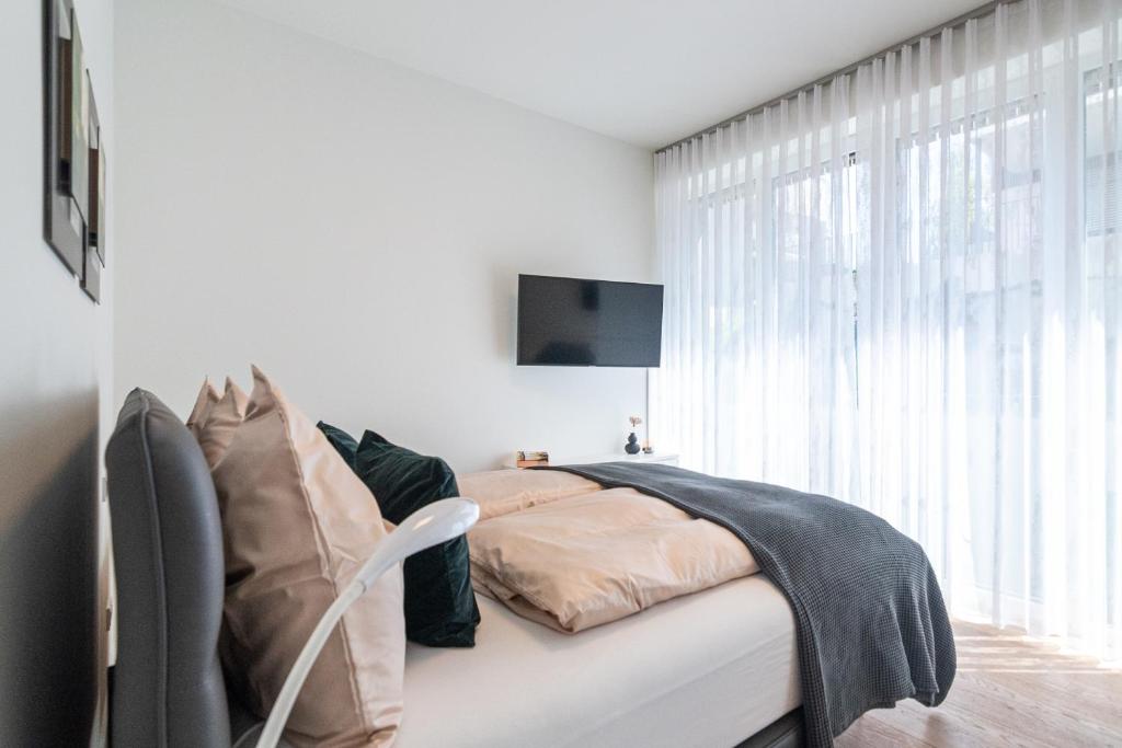 Postel nebo postele na pokoji v ubytování Hermitage Wörthersee Penthouse Appartement