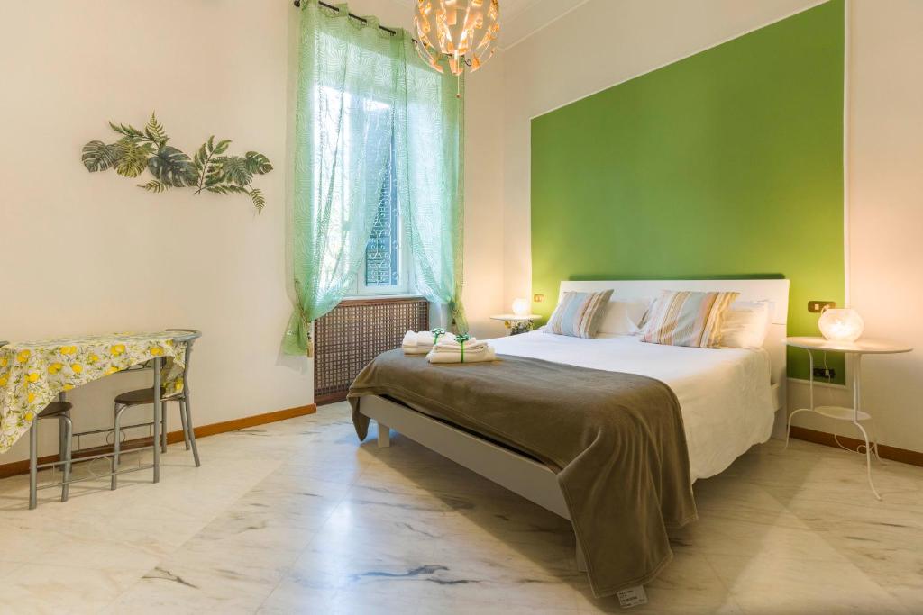 a bedroom with a bed and a green wall at La Casa Del Sole A Mergellina in Naples