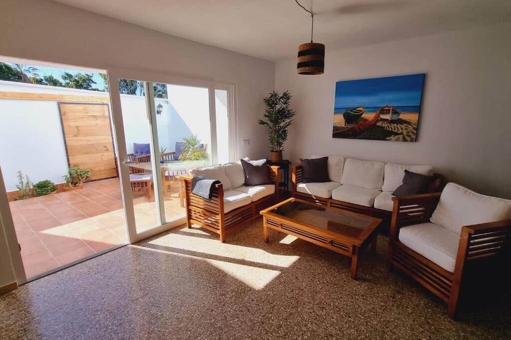 a living room with two couches and a table at La Tejita Holiday House in La Tejita